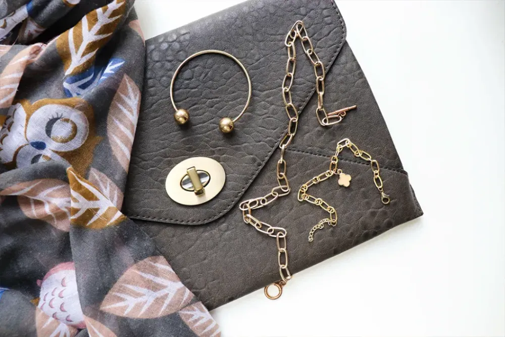 women's accessories. leather handbag, light scarf and jewelry
